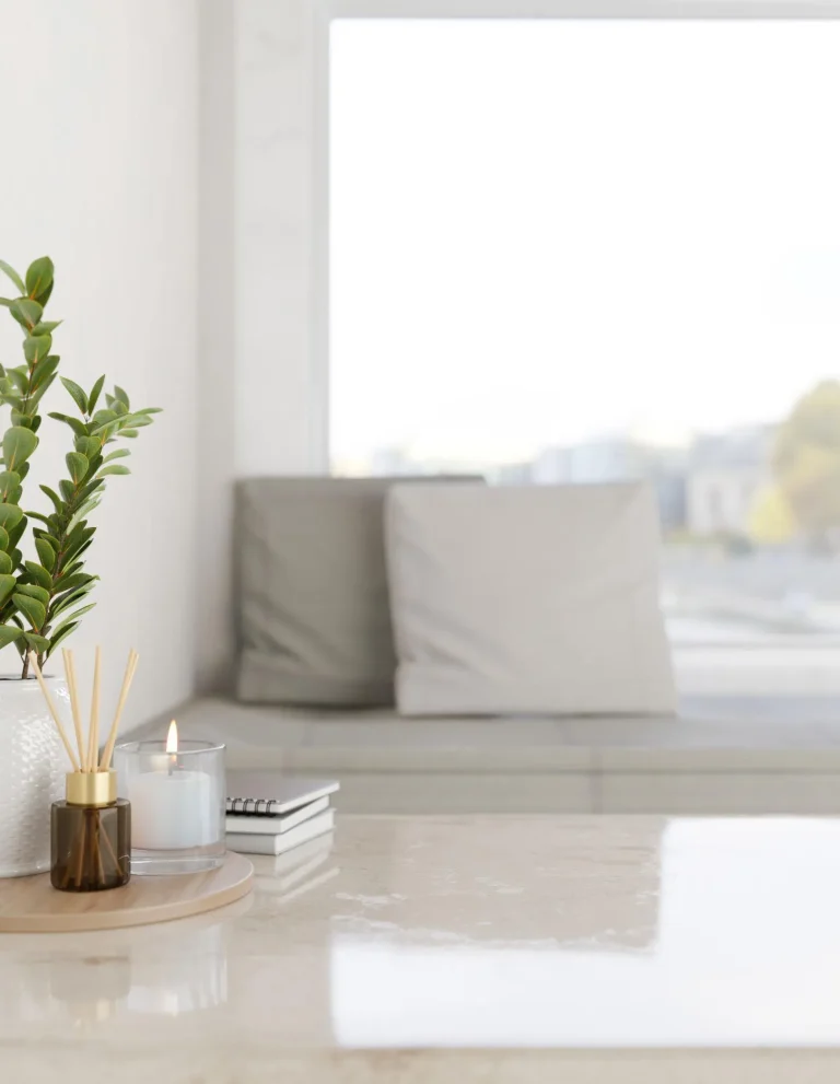 Modern living room coffee table styled with decorative books, ceramic vase and candle in warm neutral interior