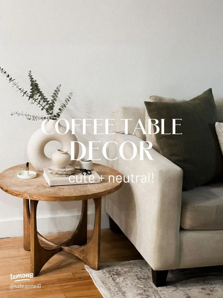 Neutral coffee table books styled with ceramic decor, candle and warm beige interior elements