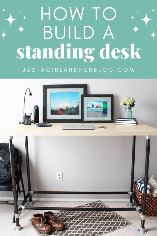 Home office standing desk with drawers, shelf storage, and monitor setup beside a measuring tape and notepad