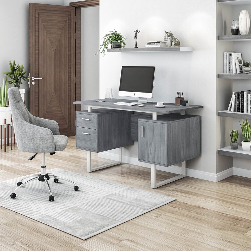Professional working at a modern office desk with drawers and shelves in a tidy home office
