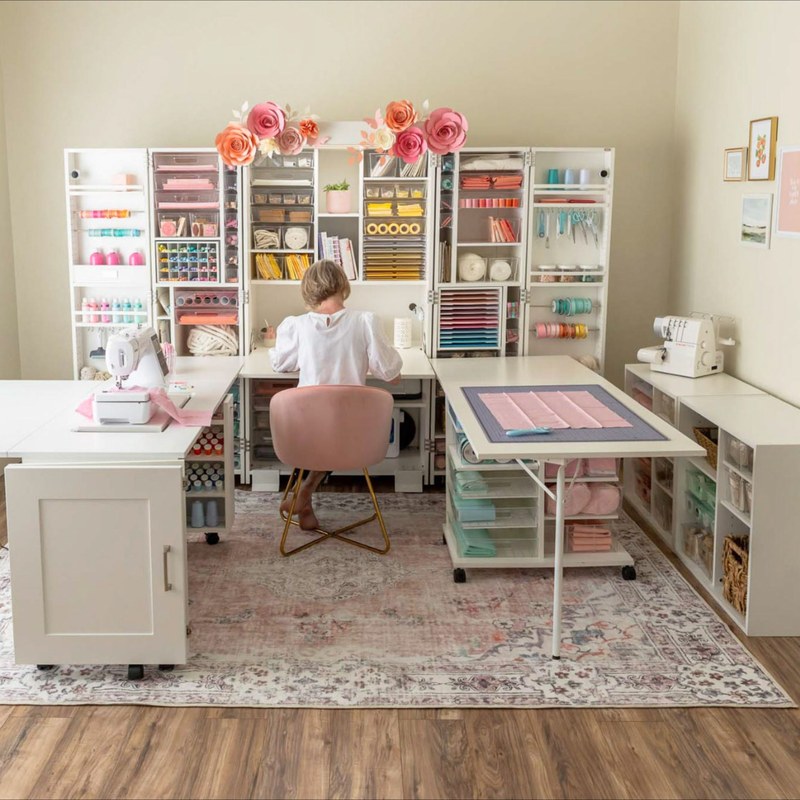 Craft desk with drawers and shelves placed in a bright room to compare storage fit by space