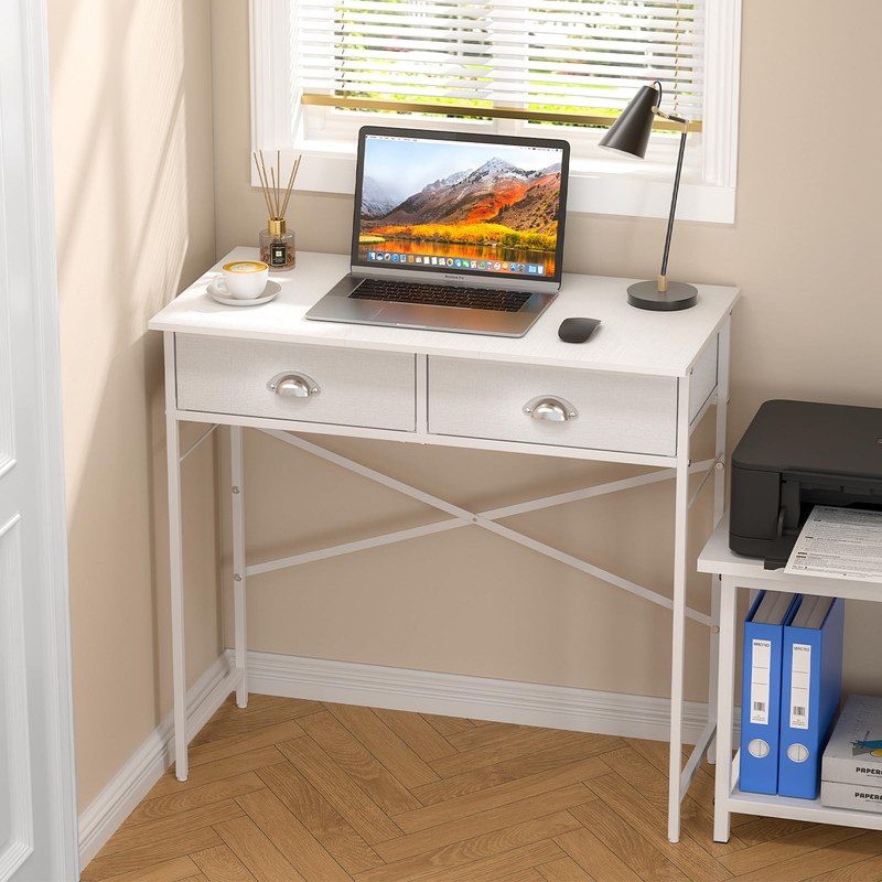 Small writing desk in a compact room with chair, lamp, and shelves showing fit in limited space