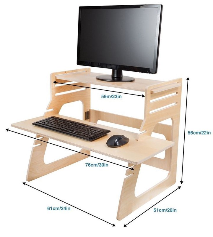Person measuring monitor height and keyboard position on a DIY standing desk converter for ergonomic fit