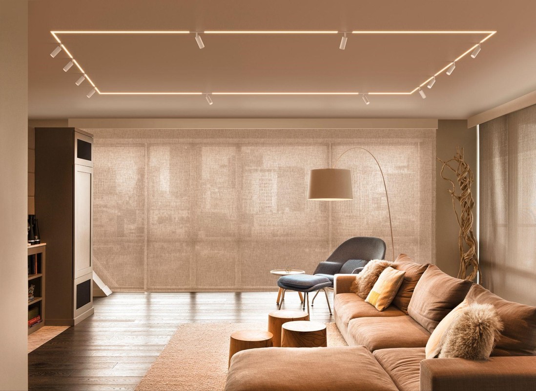 Sunlight across a living room wall and sofa, showing bright and shaded areas before hanging framed art