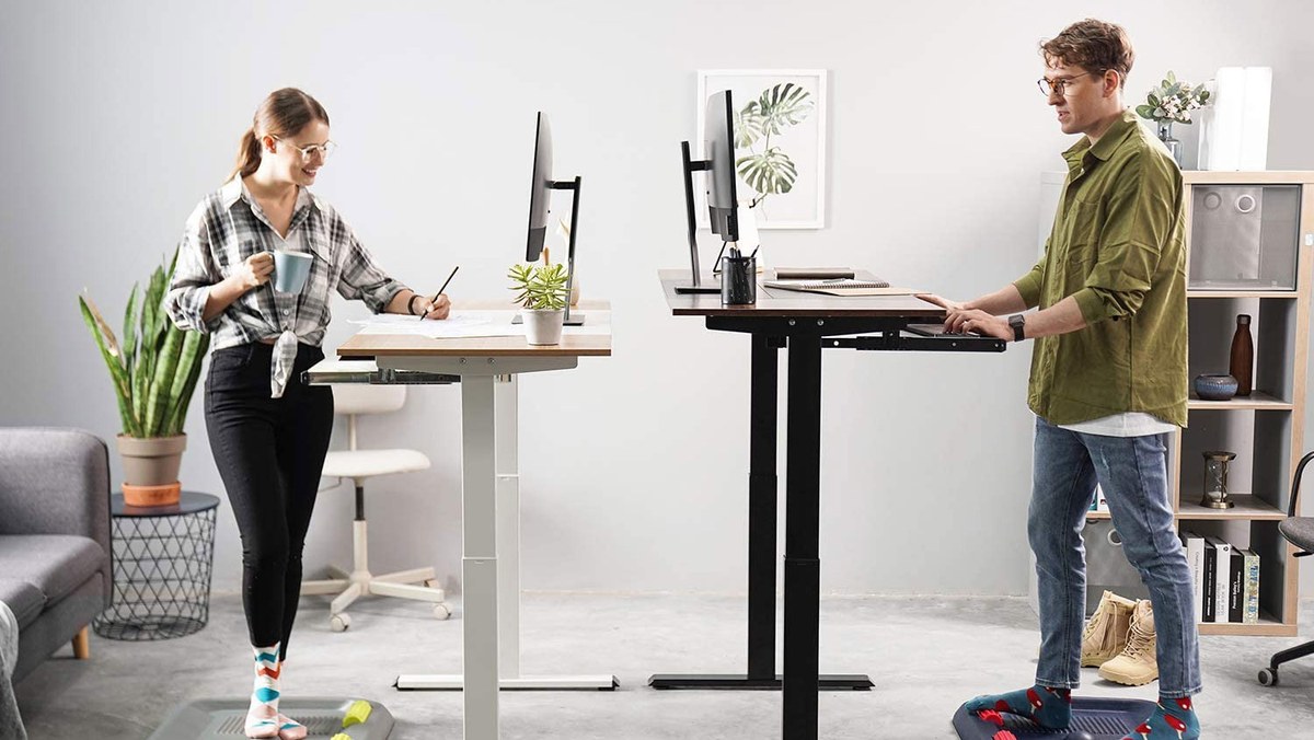 Standing desk setup in a home office with chair, monitor, and shelves showing room fit and workflow