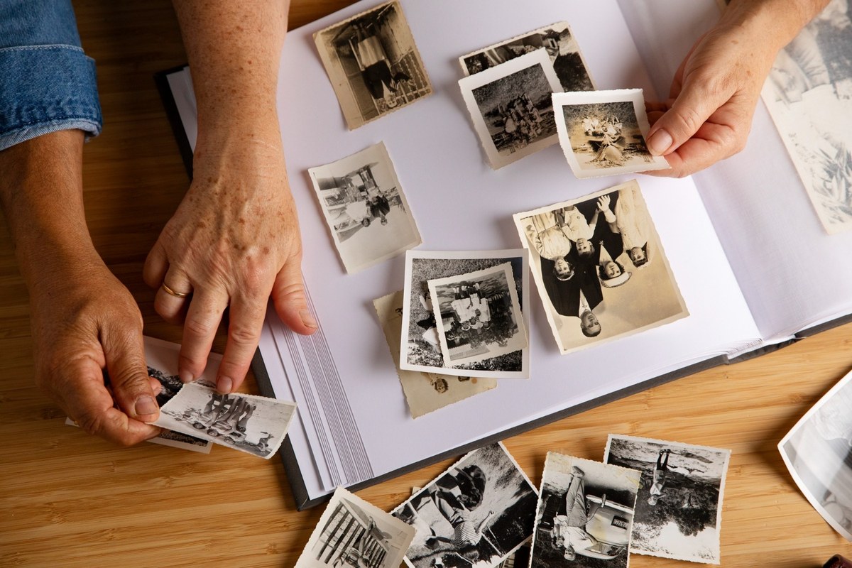 Old family photographs showing fading, yellowing, and mold damage from improper storage.