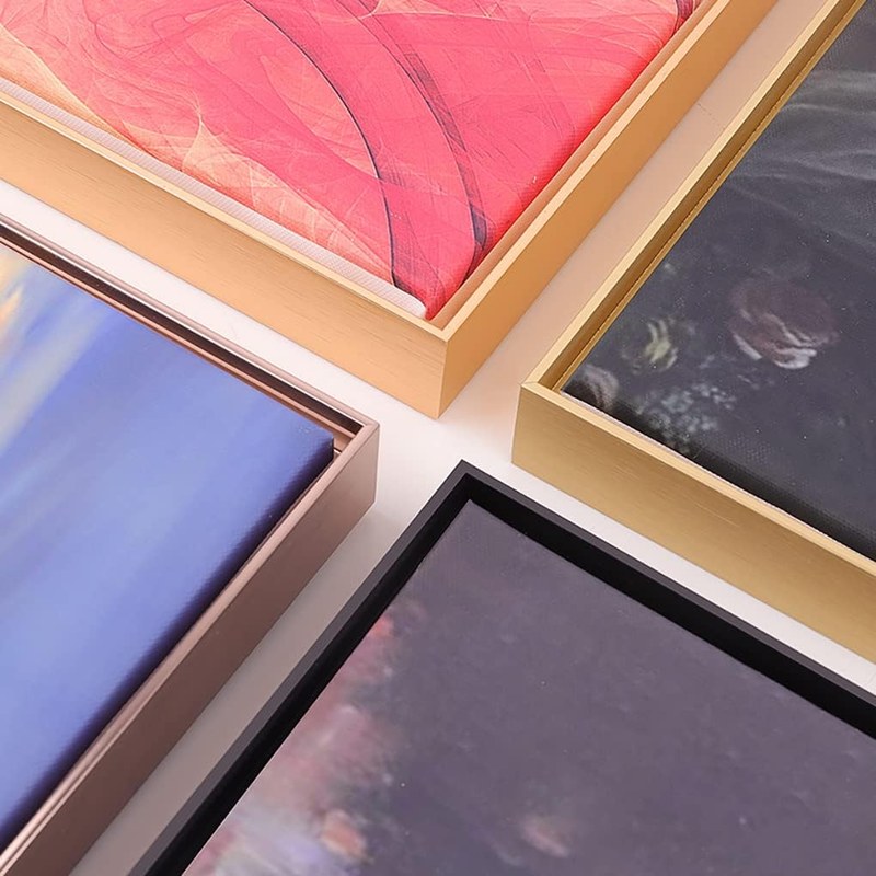 Comparison of framed canvas art with glass and without glass mounted on a living room wall